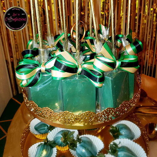 Emerald green and gold rice krispie treats with green, gold, and black bows